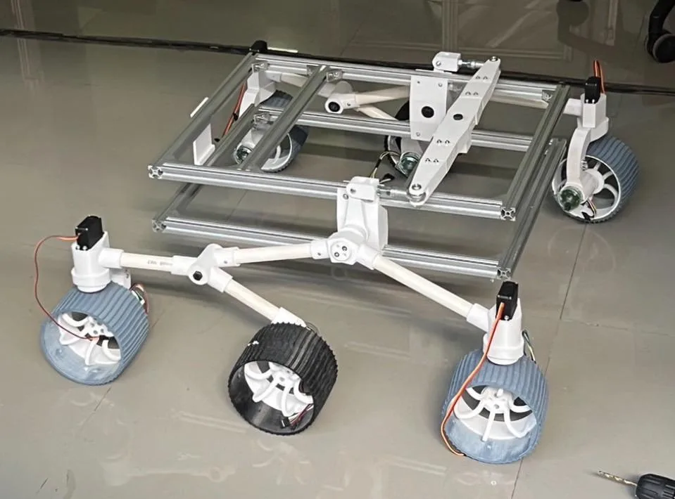 The assembled t-slot aluminium chassis on the workshop floor with the differential bar fitted