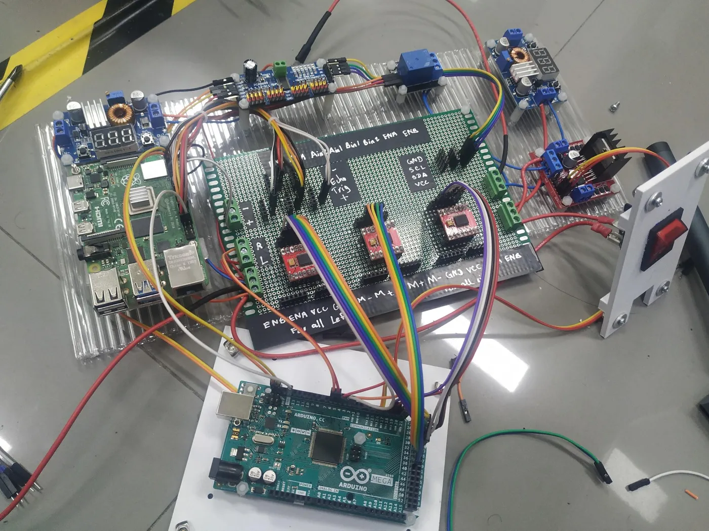 The wired electronics deck, with the Raspberry Pi and Arduino Mega side by side among motor drivers and cabling